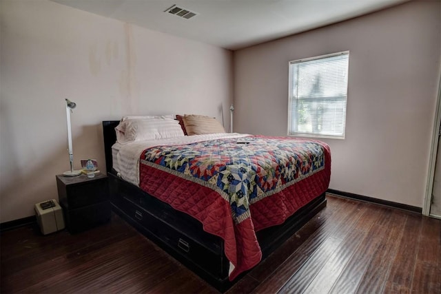 128 Gonzales St, Paige, TX 78659 - bedroom with baseboards, visible vents, and wood finished floors