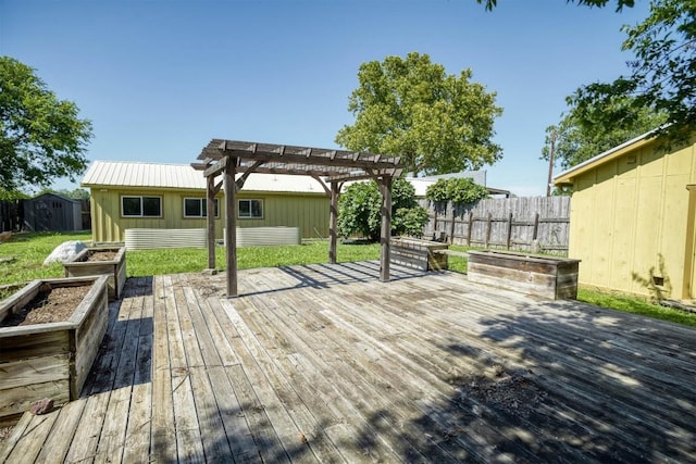128 Gonzales St, Paige, TX 78659 - wooden terrace featuring an outbuilding, fence, a storage shed, a pergola, and a vegetable garden