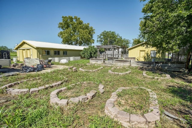 128 Gonzales St, Paige, TX 78659 - view of yard with a pergola and a vegetable garden