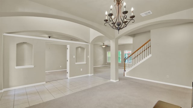 unfurnished living room featuring ceiling fan with notable chandelier and light tile patterned floors