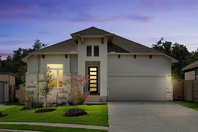 view of front of home featuring a lawn and a garage