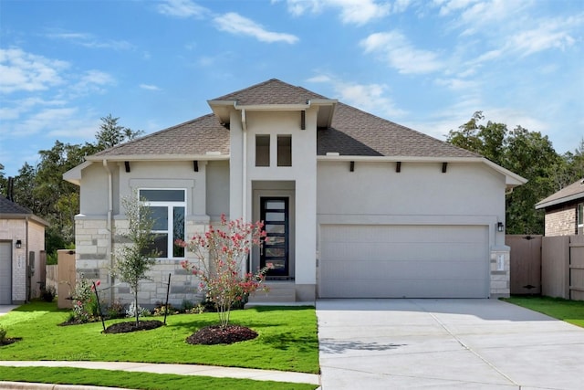 view of front of home with a garage and a front lawn