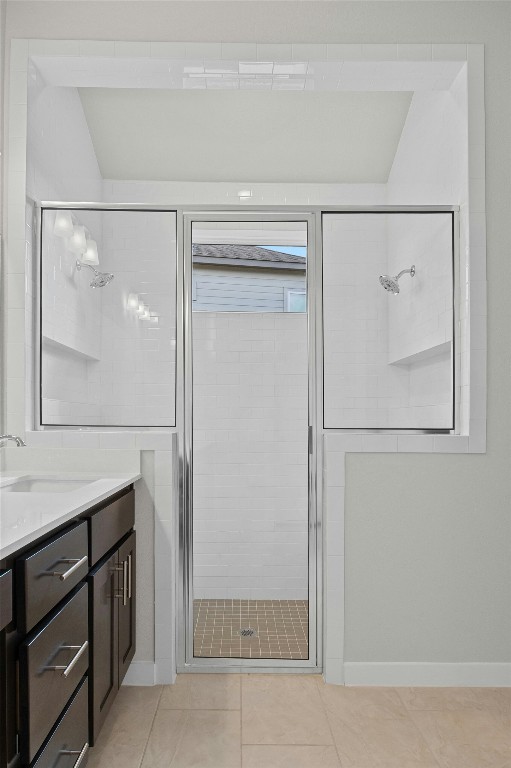 bathroom with tile patterned flooring, vanity, and an enclosed shower