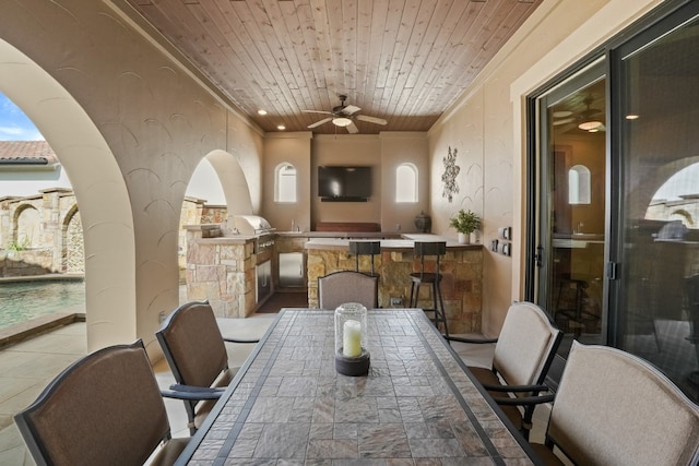 tiled dining space with wooden ceiling and ceiling fan