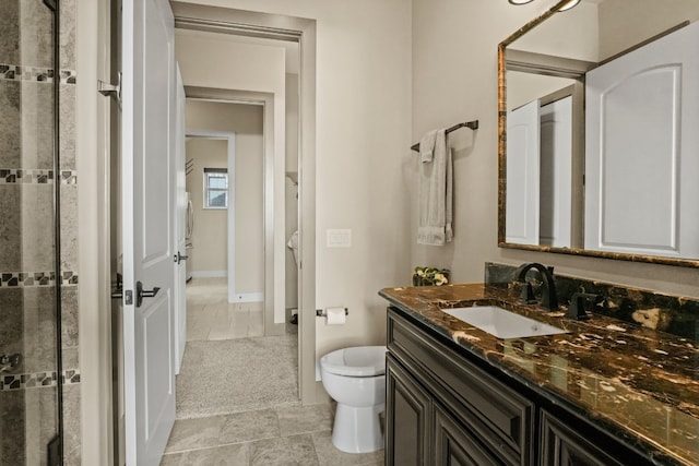 bathroom with vanity, tile patterned flooring, and toilet