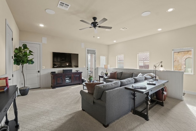 carpeted living room with a wealth of natural light and ceiling fan