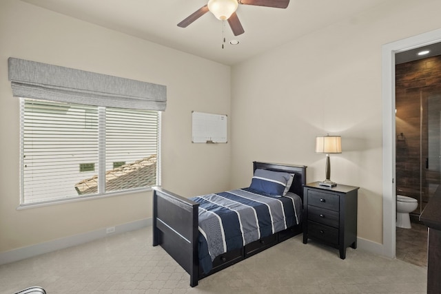 bedroom with light colored carpet, ensuite bath, and ceiling fan