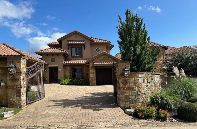 mediterranean / spanish home featuring a garage