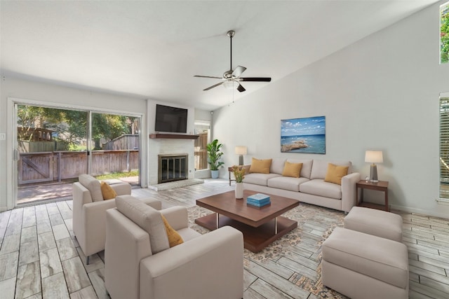 living room featuring ceiling fan, light hardwood / wood-style floors, and high vaulted ceiling