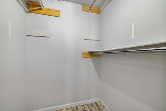 walk in closet with hardwood / wood-style floors