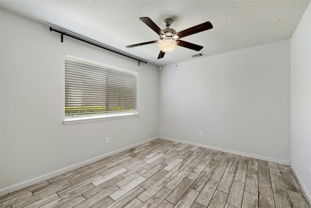 unfurnished room featuring ceiling fan and light hardwood / wood-style floors