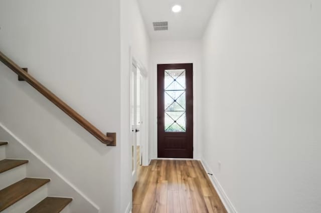 entryway with hardwood / wood-style floors