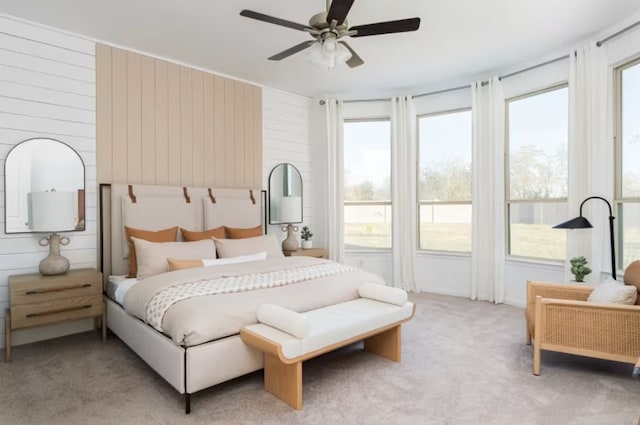 bedroom featuring light carpet and ceiling fan