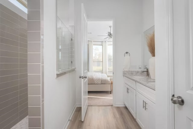 bathroom featuring hardwood / wood-style flooring, vanity, and ceiling fan