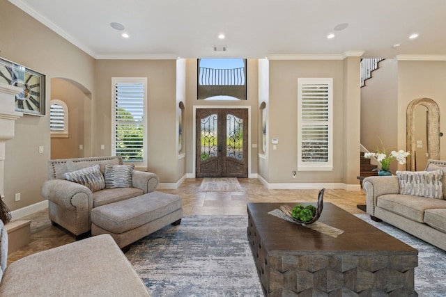 living room with dark tile patterned floors and ornamental molding