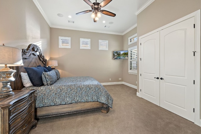 carpeted bedroom featuring crown molding, ceiling fan, and a closet