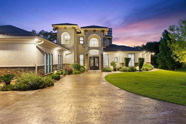 mediterranean / spanish-style house featuring a yard