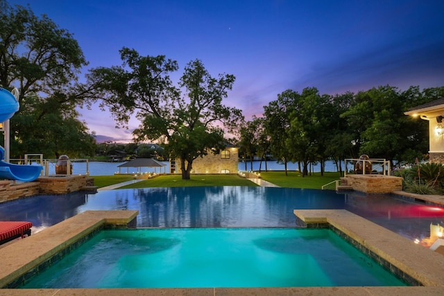 911 Legends Pkwy, Kingsland, TX 78639 - view of pool featuring an infinity pool, a yard, and a water view