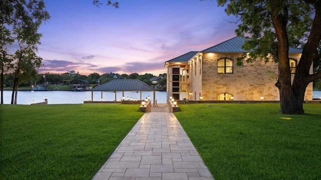 exterior space with a water view and a yard