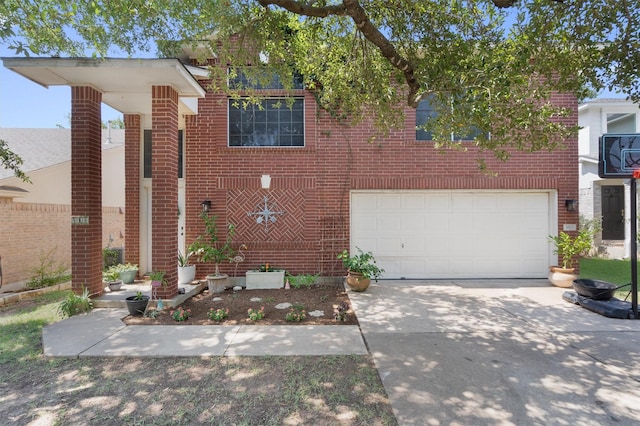 view of front facade with driveway, an attached garage, and brick siding