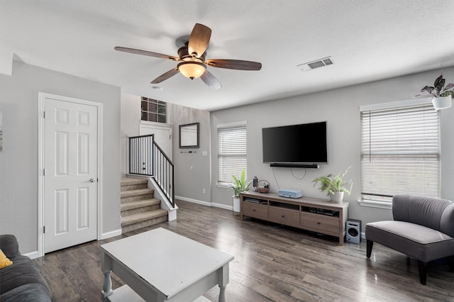 living room with dark hardwood / wood-style flooring, plenty of natural light, and ceiling fan