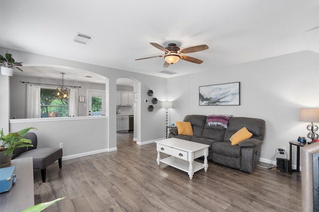 living room with vaulted ceiling, hardwood / wood-style floors, and ceiling fan with notable chandelier