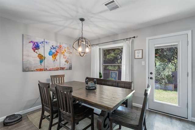 dining room featuring plenty of natural light, a chandelier, and wood-type flooring