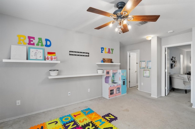 playroom featuring light carpet and ceiling fan