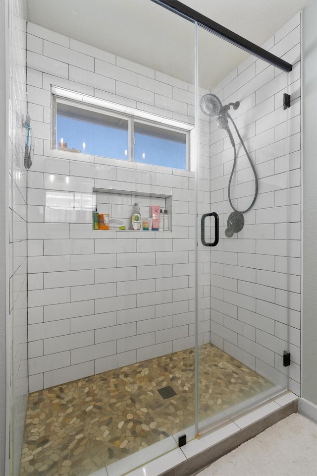 bathroom featuring a healthy amount of sunlight and an enclosed shower