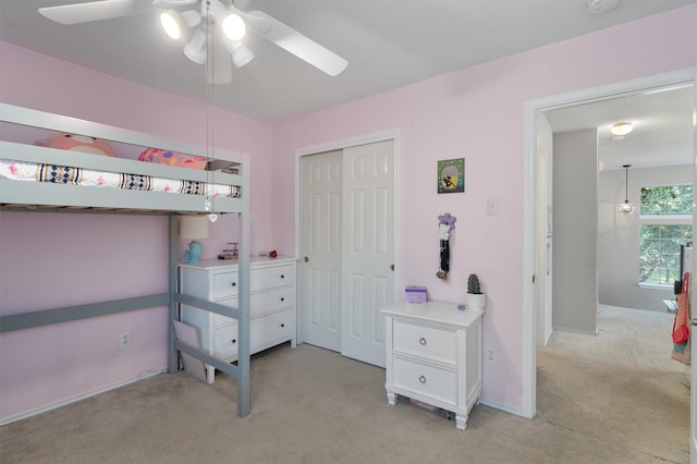 carpeted bedroom with a closet and ceiling fan