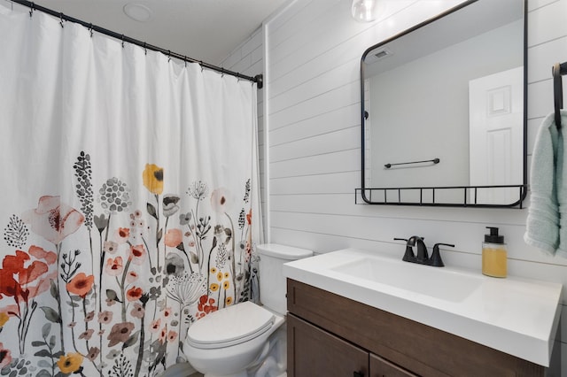 bathroom featuring vanity, a shower with curtain, toilet, and wood walls