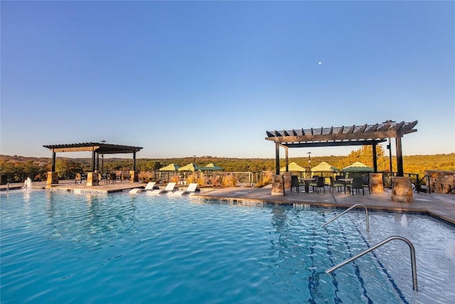 view of pool featuring a pergola and a patio