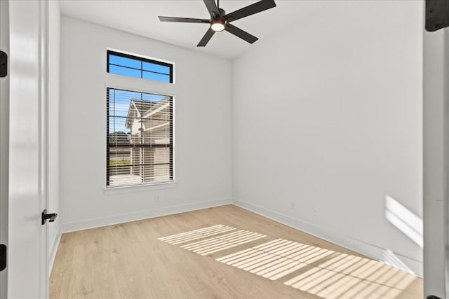 spare room with ceiling fan and light wood-type flooring