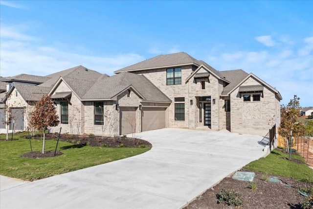 view of front of house with a garage and a front lawn