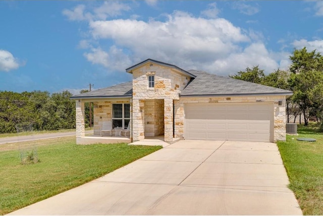 view of front facade featuring a garage, central AC, a front yard, and a porch