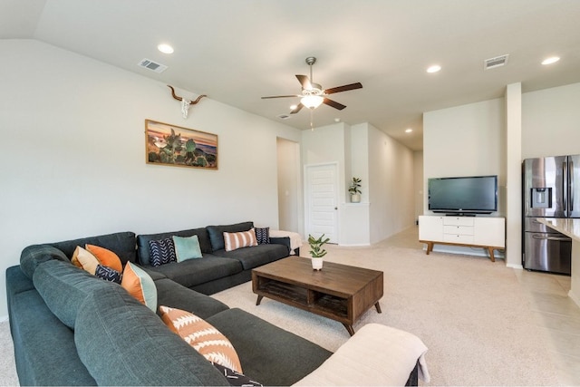 living room featuring light tile patterned floors, ceiling fan, and vaulted ceiling