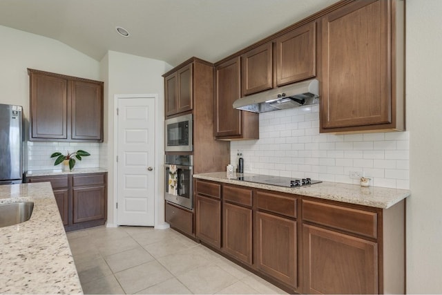 kitchen with decorative backsplash, black appliances, and light tile patterned floors