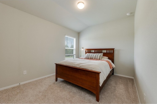 carpeted bedroom featuring vaulted ceiling