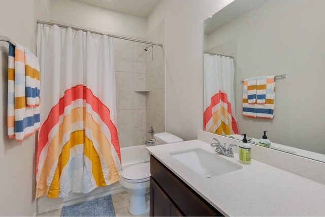 full bathroom with vanity, shower / bathtub combination with curtain, tile patterned flooring, and toilet