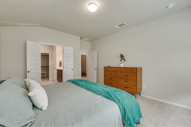 bedroom featuring light carpet and vaulted ceiling