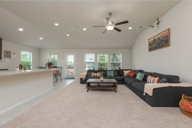 living room featuring ceiling fan, lofted ceiling, and a healthy amount of sunlight