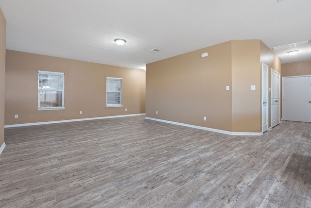 unfurnished room with hardwood / wood-style flooring