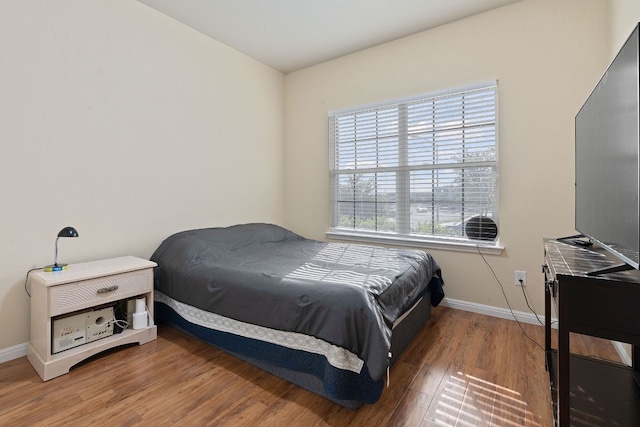 bedroom with hardwood / wood-style floors