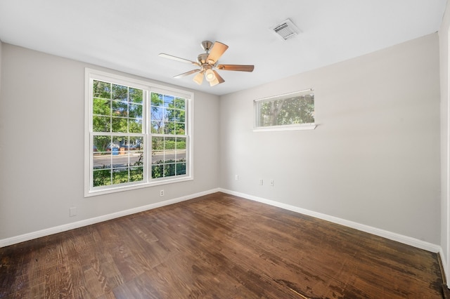 unfurnished room with dark hardwood / wood-style flooring and ceiling fan