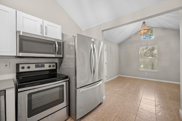 kitchen featuring tasteful backsplash, stainless steel appliances, vaulted ceiling, hanging light fixtures, and light tile patterned floors