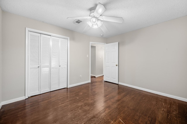 unfurnished bedroom featuring hardwood / wood-style flooring, a textured ceiling, a closet, and ceiling fan