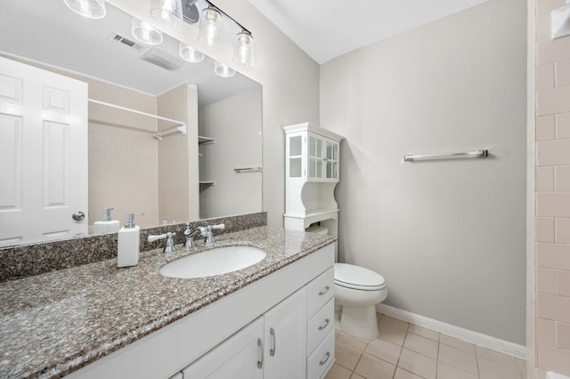 bathroom featuring vanity, tile patterned flooring, and toilet