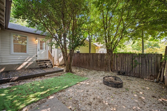 view of yard with an outdoor fire pit