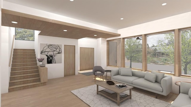 living room with stairs, recessed lighting, plenty of natural light, and light wood-style floors