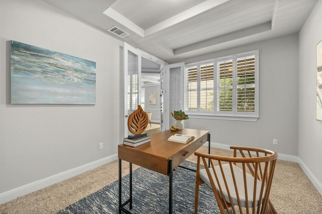 office with carpet floors and a tray ceiling